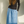 Load image into Gallery viewer, A stylish and fashionable woman wearing a long blue denim viscose skirt paired with a long black turtleneck. This outfit is both comfortable and trendy, perfect for any occasion. made in Montreal.
