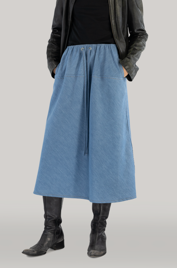 A stylish and versatile long viscose denim skirt with practical pockets, perfect for any occasion and ideal for the modern and fashion-conscious woman.