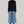 Charger l&#39;image dans la galerie, woman standing with short black hair, wearing a fitted black long-sleeve turtleneck and long midi blue denim skirt. styled with maroon boots and gold necklace
