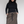 Load image into Gallery viewer, Woman standing with long black wavy hair, plus size. wearing black fitted turtleneck and long brown wool skirt and black drawstring tied in a bow.
